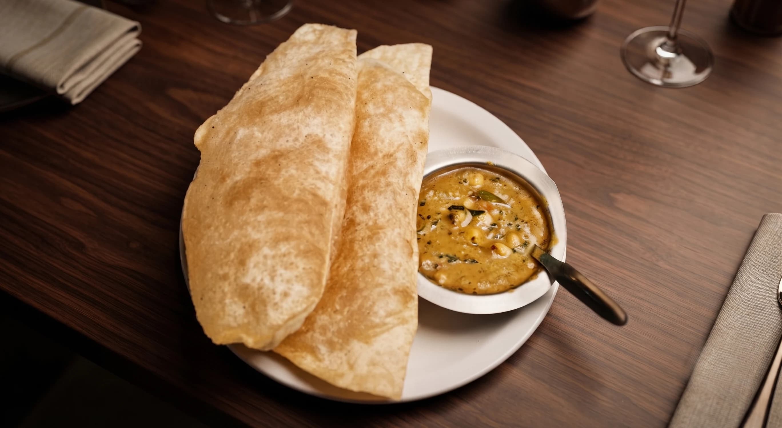 Fluffy bhatura served with spiced chickpea curry