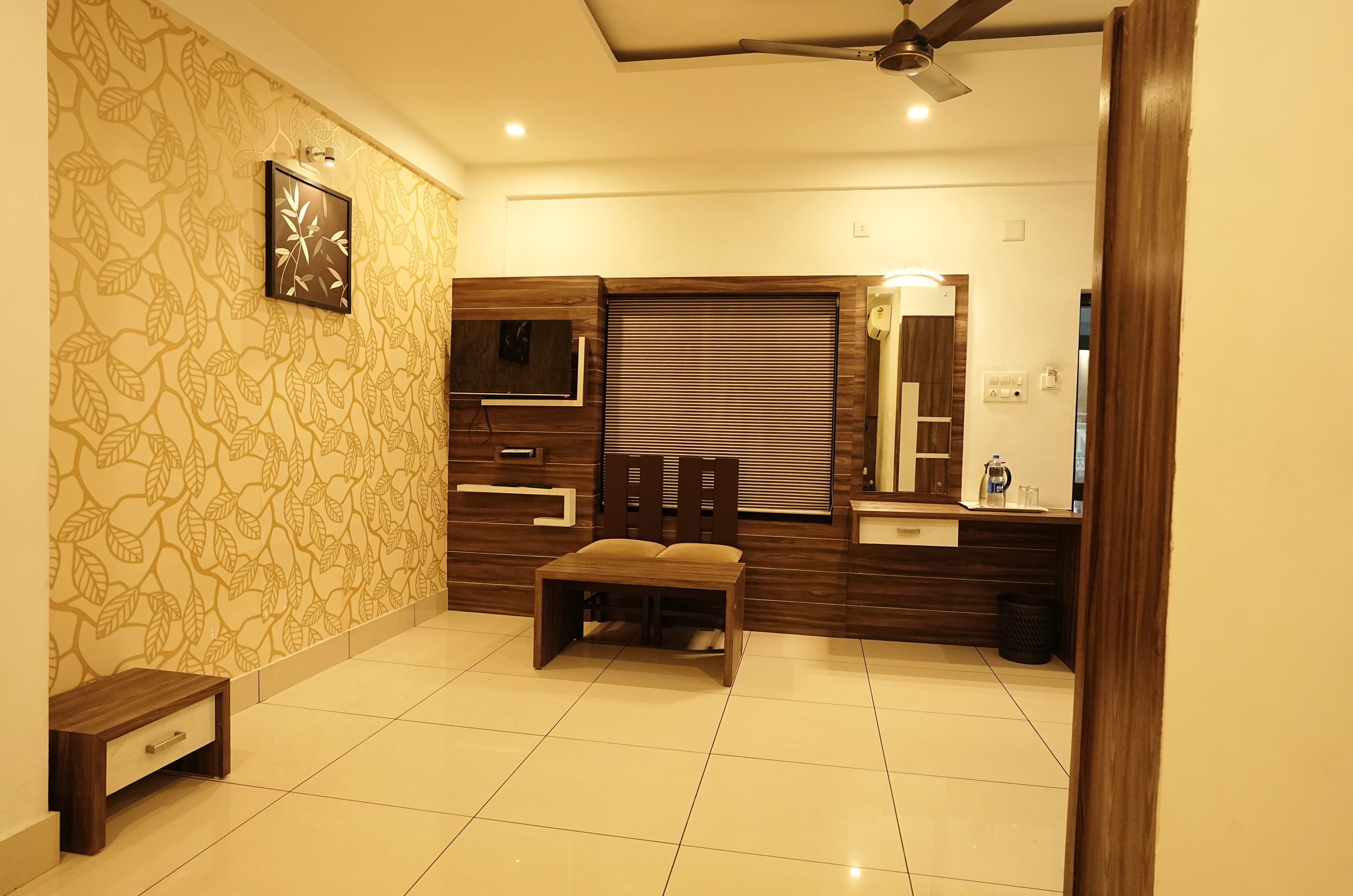 Seating corner in an Affas Udupi Hotel room Kalpetta
