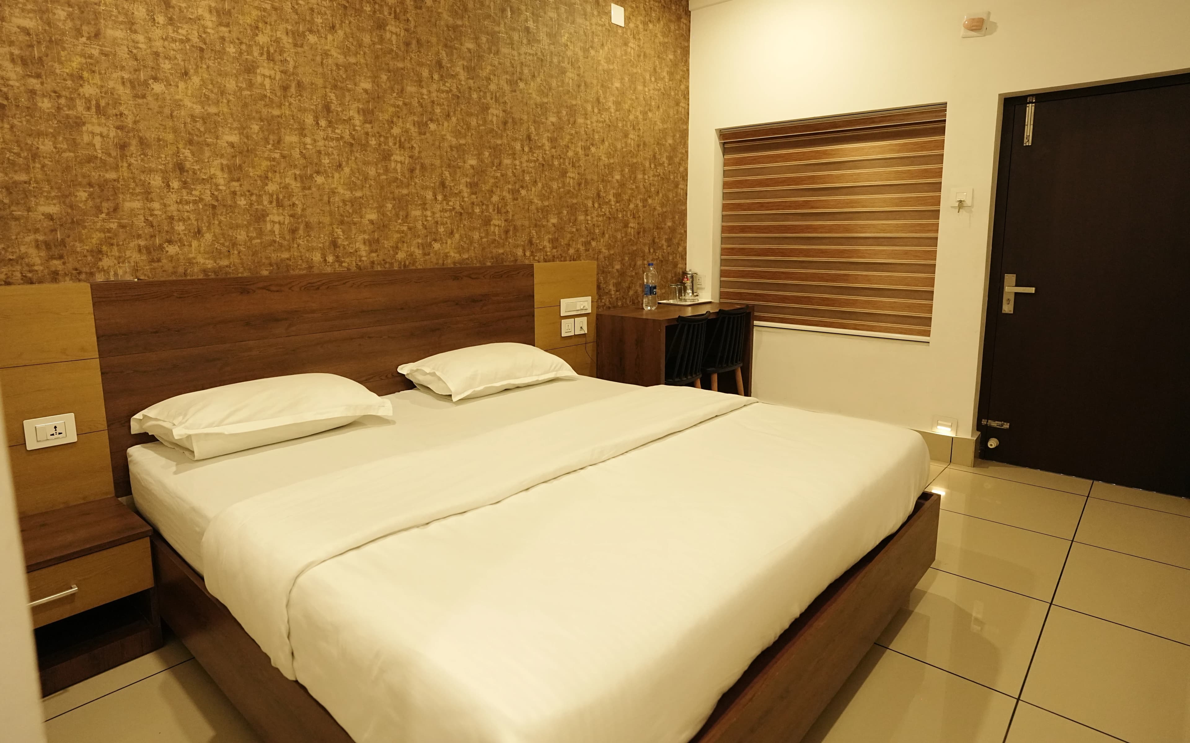 Affas hotel bedroom with bed and warm interior lighting